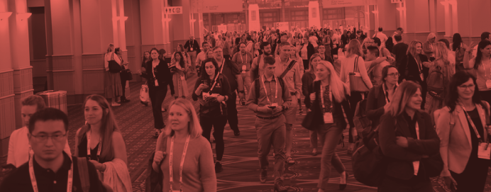 Crowd of attendees walking down convention center hallway