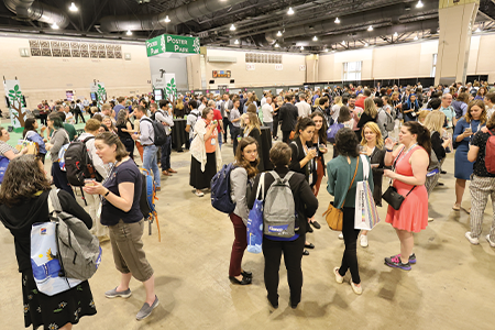 Crowd of people mingling in Exhibit Hall near Poster Park.