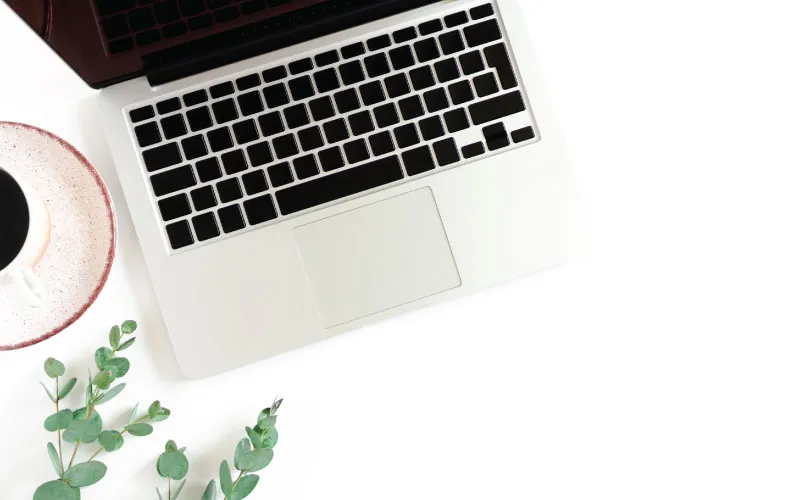 Laptop open on white desk