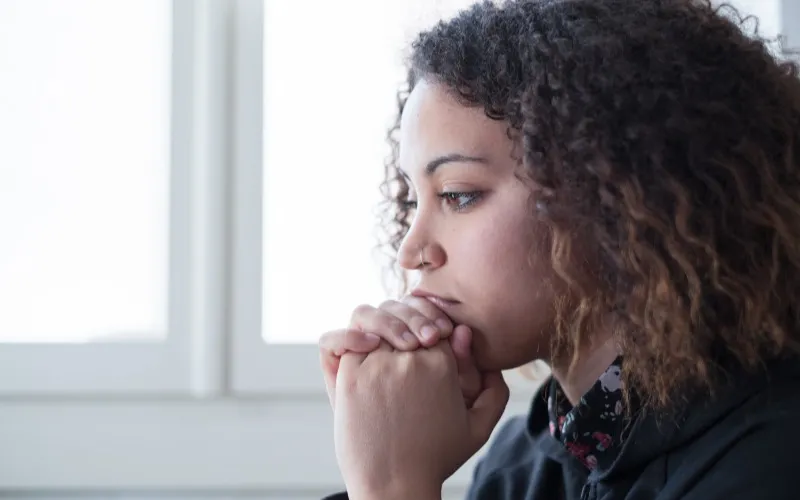 Woman looking toward the left somberly