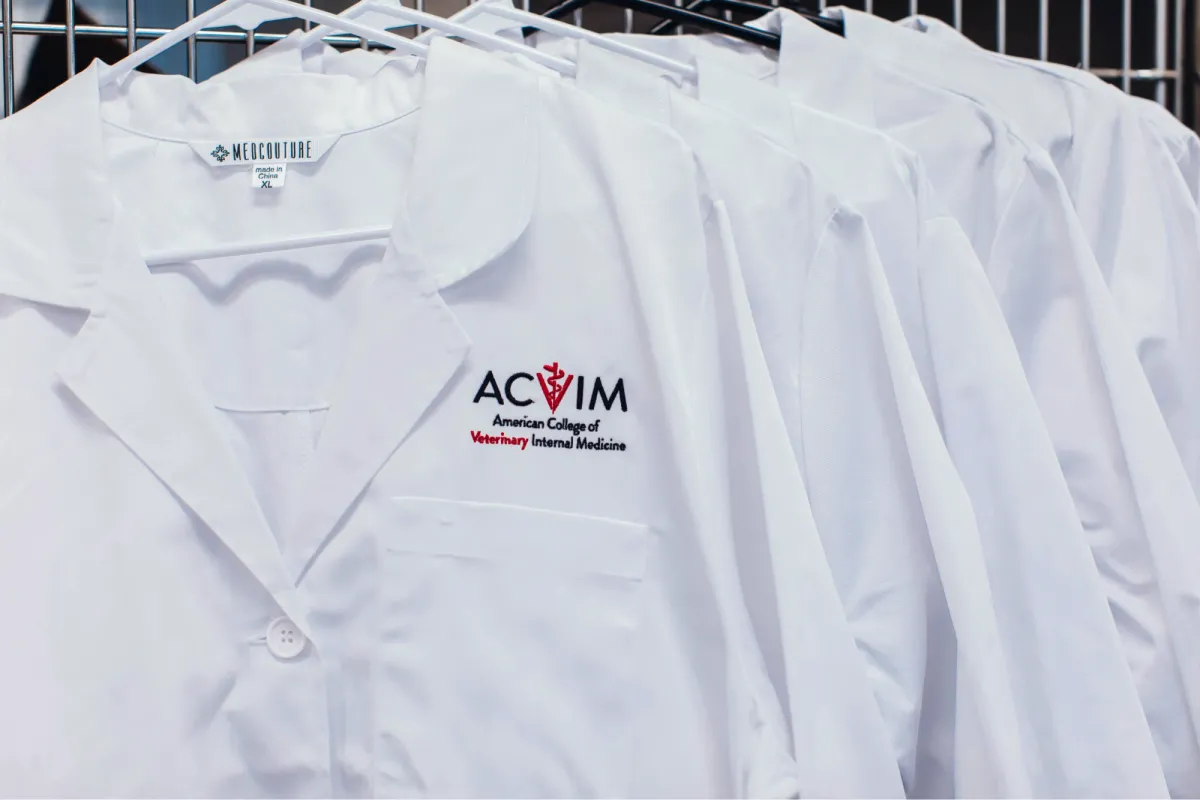 White lab coats with the ACVIM logo