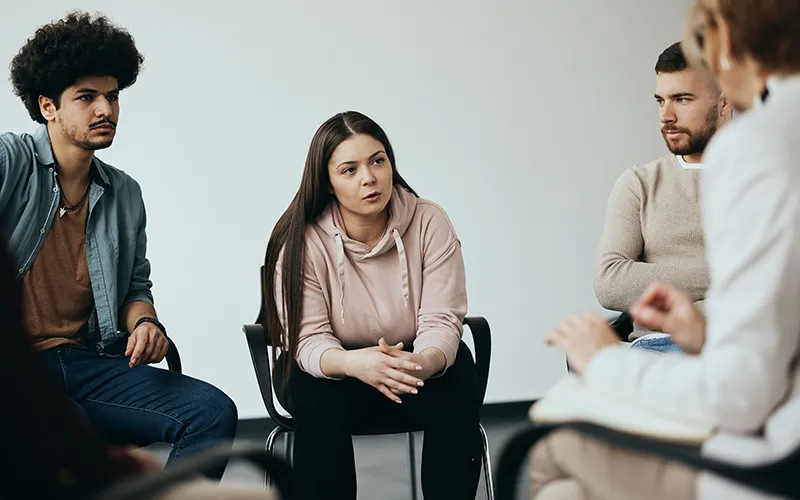 Seated people talking in a circle