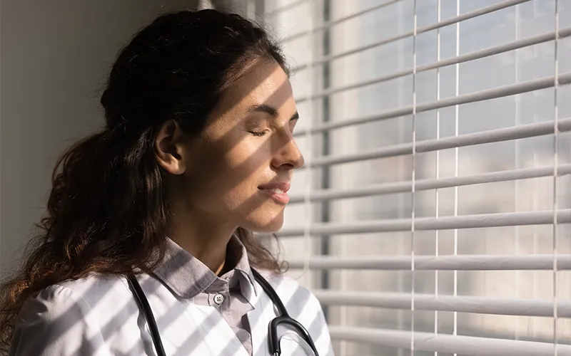 Veterinarian looking out a window