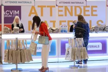 People getting a bag at Attendee Materials desk
