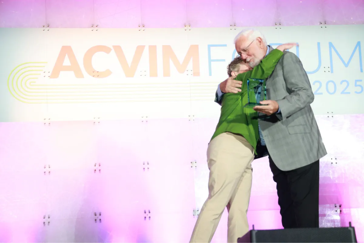 Joan Coates embraces Bill Fenner during the 2025 ACVIM Forum Awards Ceremony