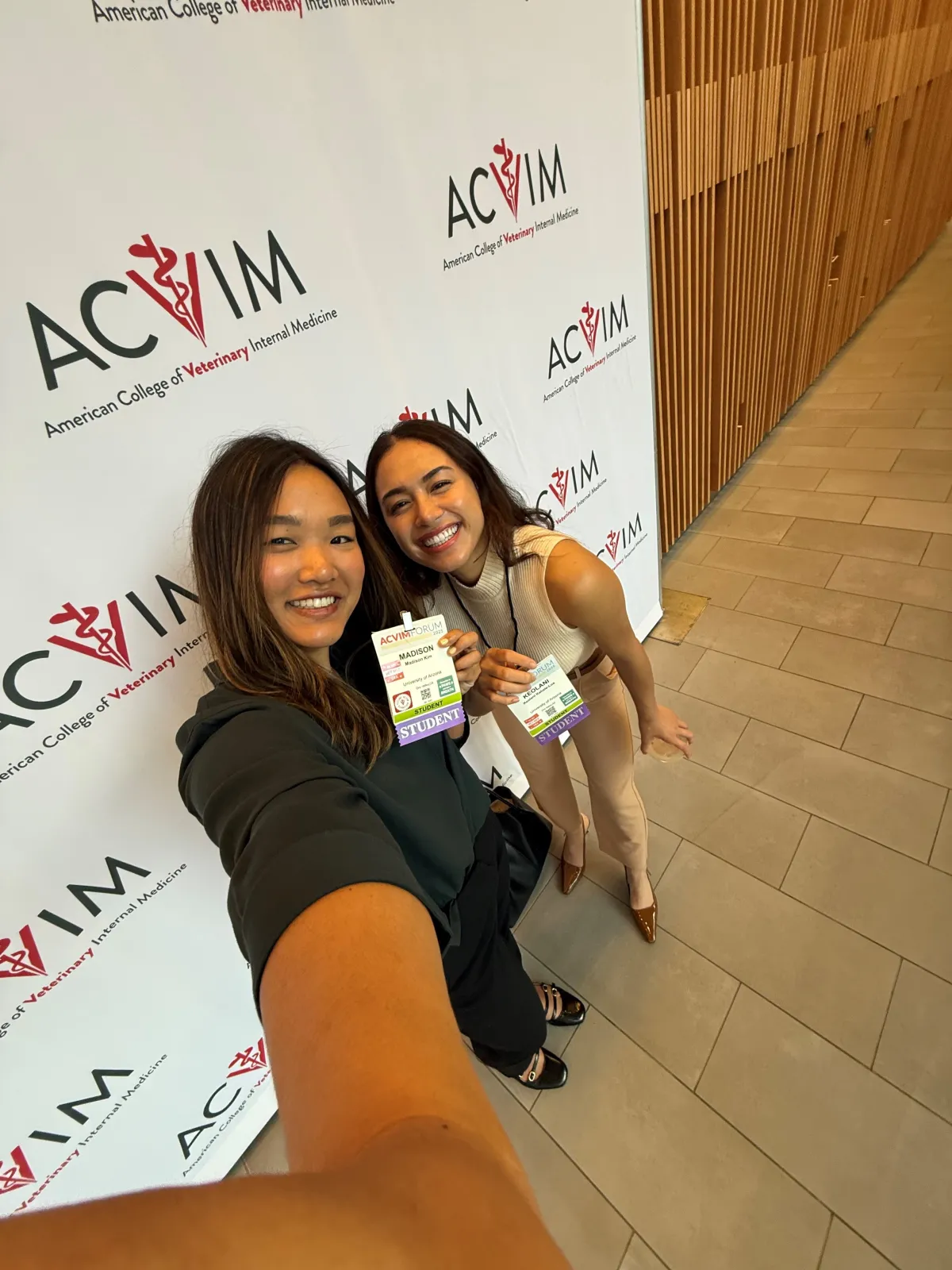 Two ACVIM Student Chapter members pose and smile at the 2025 ACVIM Forum 