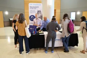 Attendees during break at exhibitor table
