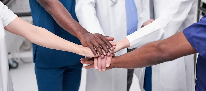 veterinarians putting hands in a circle