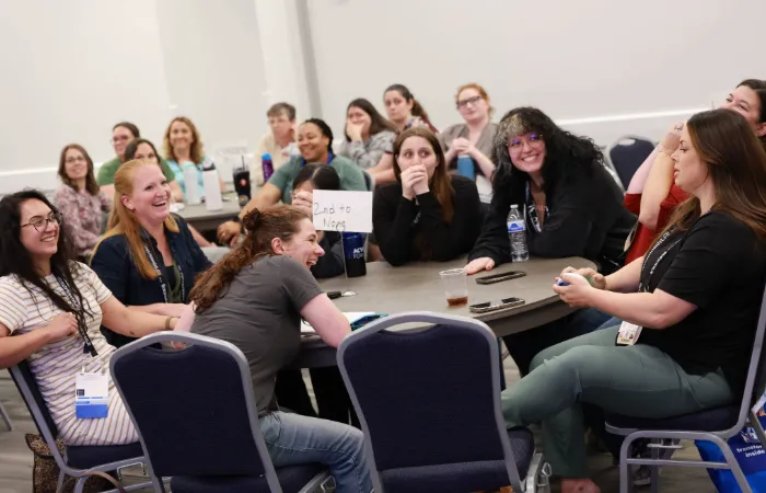 Technicians laughing at round table