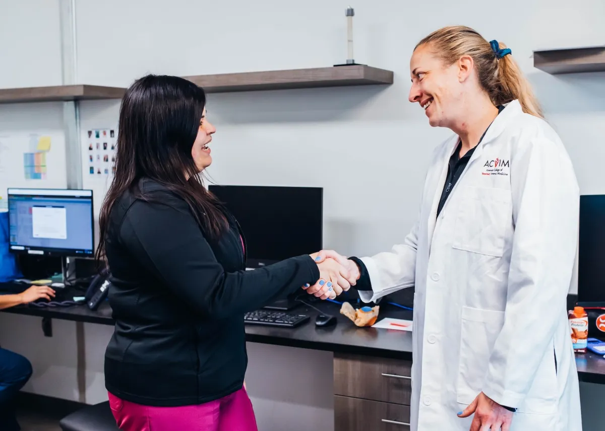 Vet specialist shaking hands with somebody