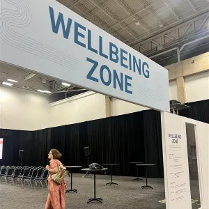 sign that reads wellbeing zone and woman walking by