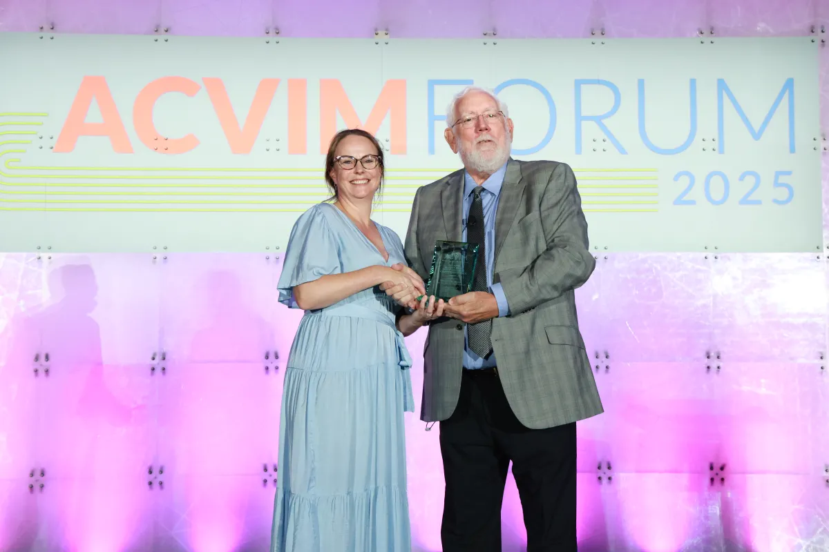 Woman and man shaking hands on stage 