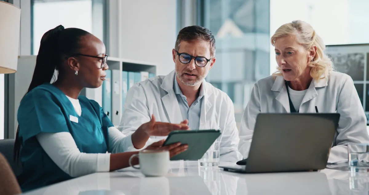 Veterinarians at a table looking at a tablet