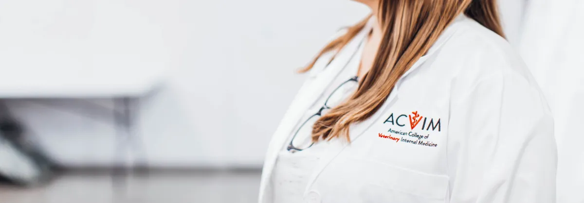 ACVIM logo on a white coat