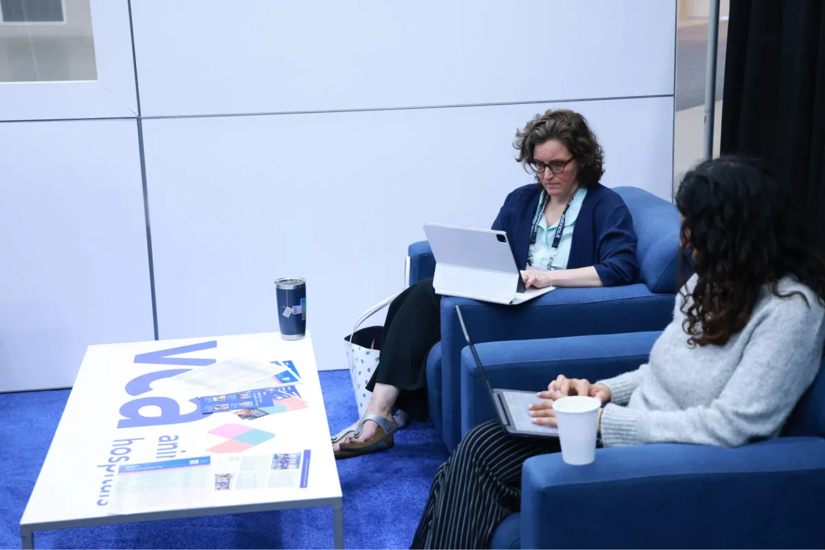 Two Diplomates work on their laptops in the specialist lounge during the ACVIM Forum