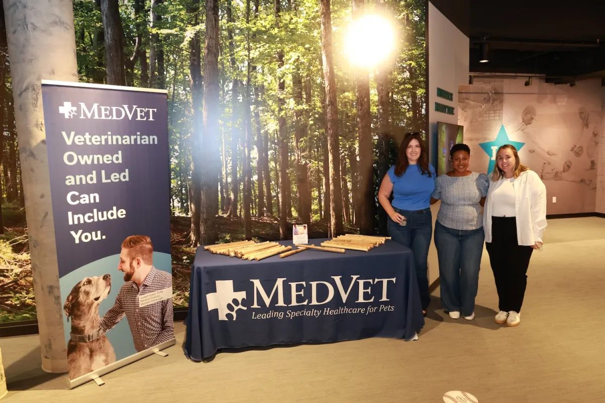 Sponsors at event with branded table and sign
