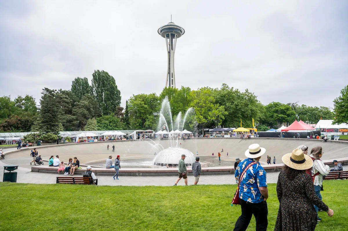People walking around fountain with Seattle space needle in background