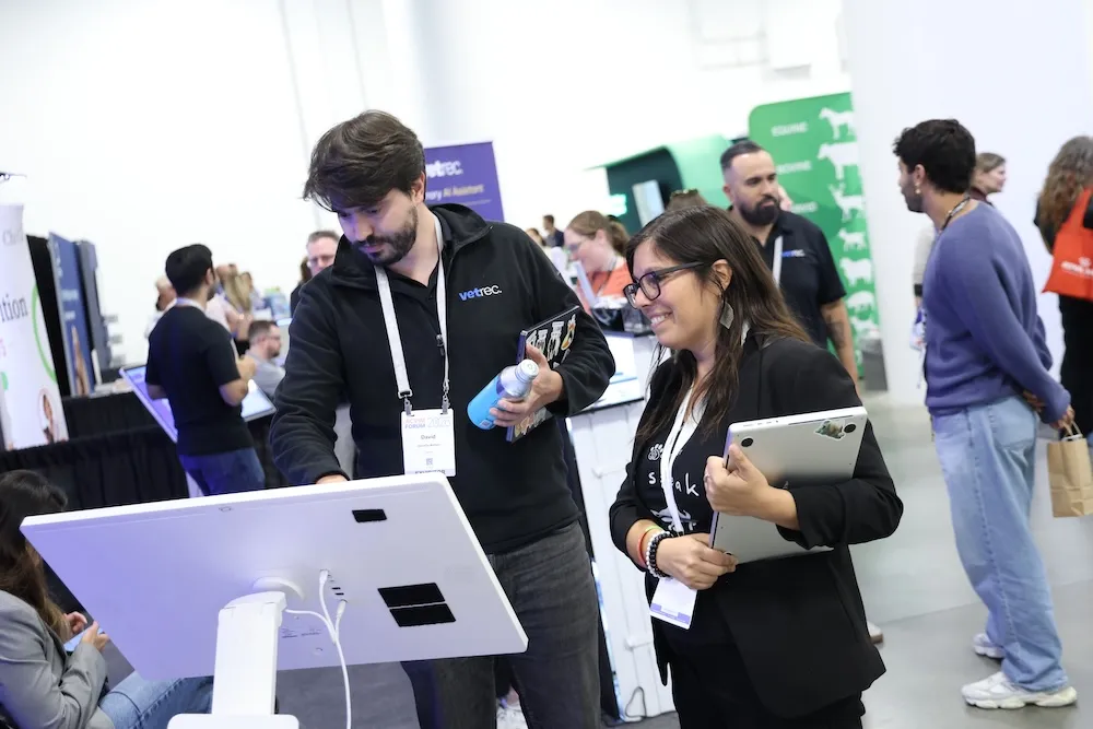 Attendee and exhibitor looking at screen