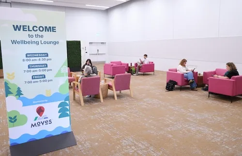 Wellbeing Lounge sign with people relaxing in back ground