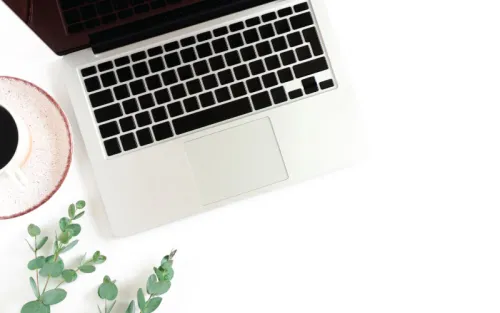 Laptop open on white desk