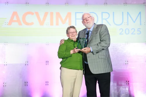 Joan Coates accepts the 2025 Kirk Award from Dr. William Fenner