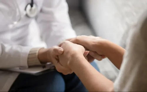 Veterinarian holding the hands of a client