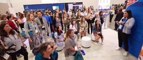 Attendees listening to presenter in Exhibit Hall