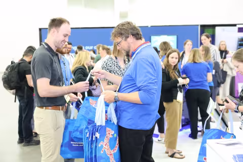 Exhibitor handing out branded bags
