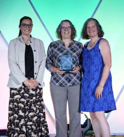 Cameon Ohmes, Chris Sanchez and Sarah Gillings pose on stage during the 2026 ACVIM Awards Ceremony