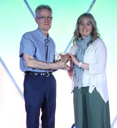 Al Jergens and Jana Raessler pose on stage during the 2026 ACVIM Awards Ceremony